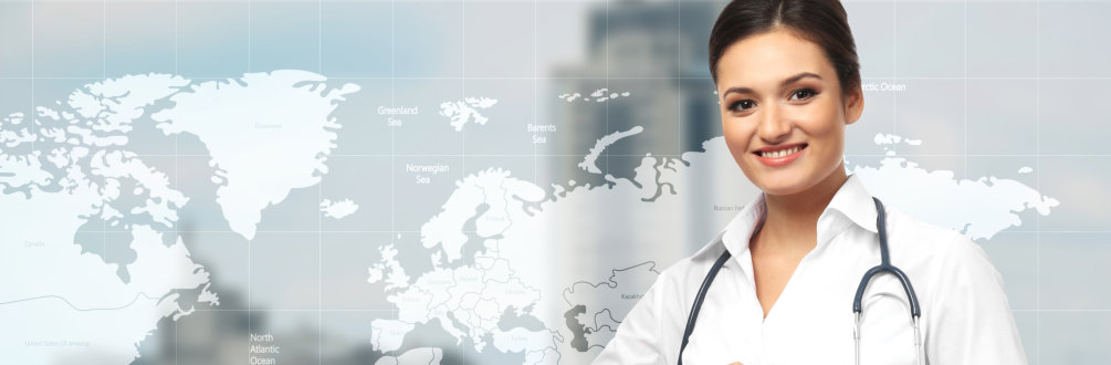 a female doctor smiling while in front of a world map