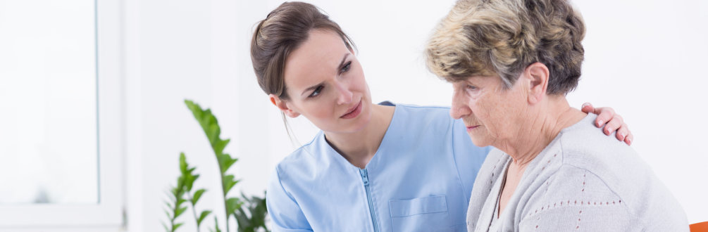 a female medical staff taking comforting an elder