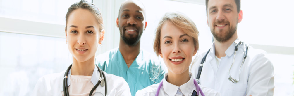 a group of medical professionals smiling while having a photo